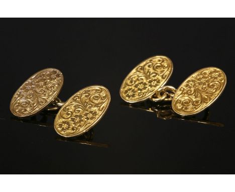 A pair of 18ct gold oval plaque chain link cufflinks, hand engraved with foliate detail.  10.41g (2)