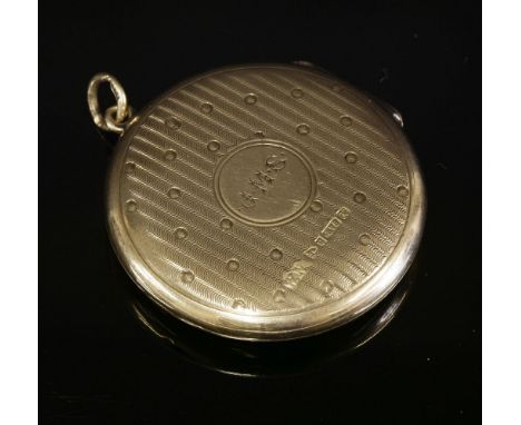 An Edwardian 9ct gold circular hinged locket, with engine turned waves and dot decoration, hand engraved initials 'J.M.S.' to