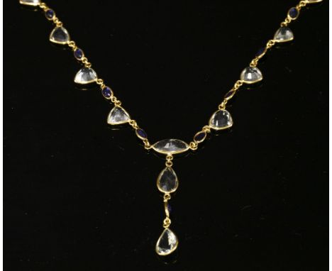 An aquamarine and sapphire 'Y' necklace,with a centrepiece composed of a series of pear cut and marquise cut aquamarines, wit