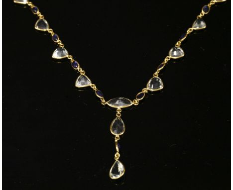 An aquamarine and sapphire 'Y' necklace,with a centrepiece composed of a series of pear cut and marquise cut aquamarines, wit