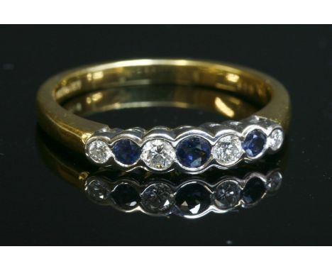 An 18ct gold graduated sapphire and diamond seven stone ring,with three circular graduated mixed cut sapphires and four gradu