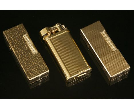 A gold-plated Dunhill lighter,with riven decoration, no. RE 24163,a gold-plated Dunhill lighter,with fine barley engine turne