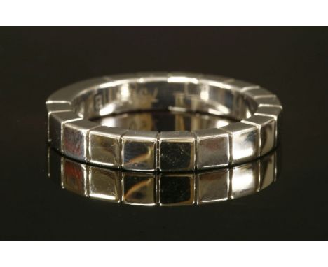 An 18t white gold Cartier Lanieres flat section band ring,with impressed Cartier signature.  Serial no. BK0709.  Marked 750. 