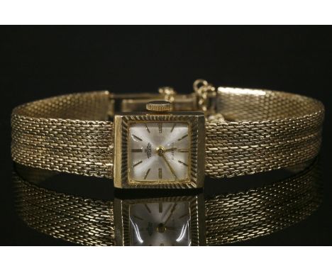 A ladies' 9ct gold trident mechanical bracelet watch,with square silvered dial, London 1964.  19.31g