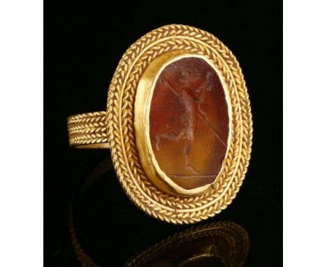 A high carat gold cornelian intaglio ring,possibly Roman, 3rd or 4th century.  A flat oval cornelian tablet, intaglio engrave