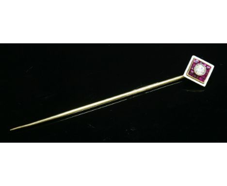 A French cased Art Deco diamond, ruby and enamel gold stick pin,an old brilliant cut diamond, milligrain set to a white colle