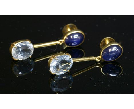 A pair of gold, sapphire and aquamarine drop earrings, with an oval cabochon sapphire, rub set to the top.  An articulated ba