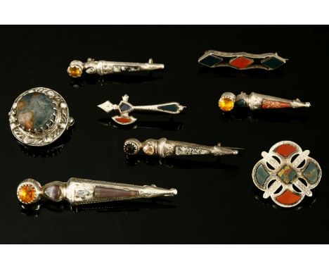 Eight assorted Scottish silver hardstone or pebble brooches, to include:a silver sword set with a yellow paste stone and inla