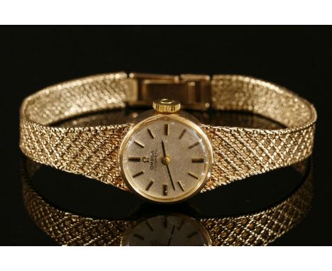 A ladies' 9ct gold Omega automatic bracelet watch,circular silvered dial, with raised gilt and black baton numerals and hands