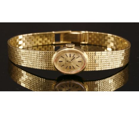 A ladies' gold Zenith mechanical bracelet watch,with an oval champagne dial with raised black batons and hands and integral b