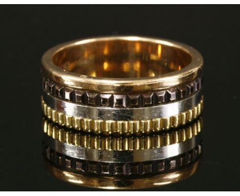 An 18ct four colour gold Boucheron cattle ring,with flat section rose and white gold bands, between hobnail and ridged yellow