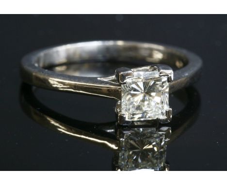 A platinum single stone diamond ring,with a princess cut diamond, estimated as approximately 1.00ct, four claw set at the cor