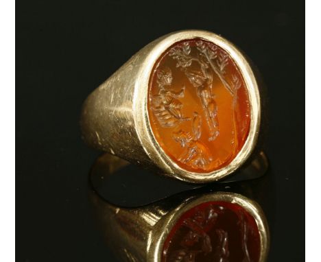 A gentlemen's mid to late 20th century gold intaglio signet ring,with an oval cornelian intaglio, possibly Georgian, later mo