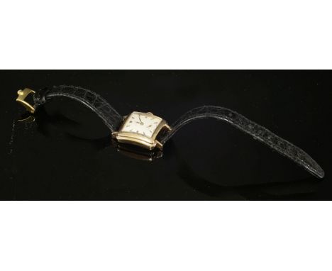 A ladies' 18ct rose gold Rolex mechanical strap watch, c.1940,with a cushion-shaped stepped case.  A square silvered dial wit