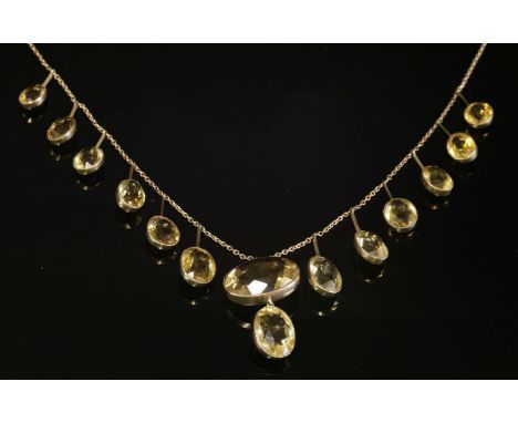 An Edwardian graduated citrine fringe necklace, with a two stone central pendant, with oval mixed cut citrines, milligrain se