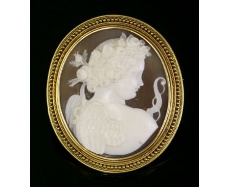 A Victorian carved shell cameo brooch depicting Cupid,with oval carved shell in white to a light brown ground.  The cameo rub