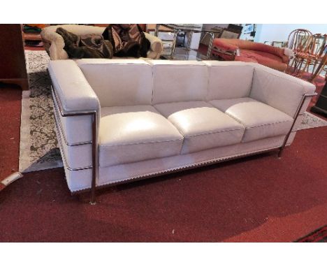 A Le Corbuster, Cassina, style white leather three seater sofa raised on chrome frame, bearing Japanese signature to base