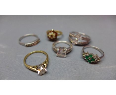 A 9ct yellow gold and diamond ring, together with a 9ct yellow gold ruby and semi precious stone dress ring, a silver emerald