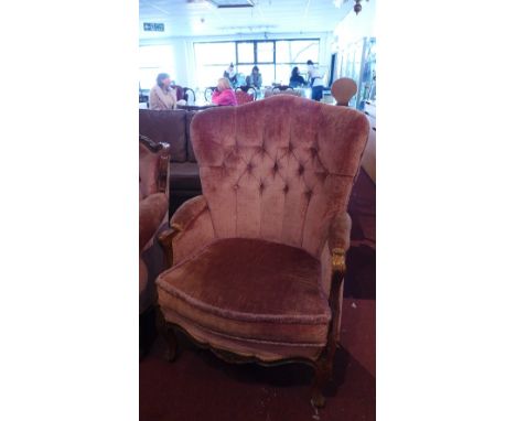 A pair of early 20th Century French walnut chairs having carved frame with pink velour button back upholstery, raised on cabr