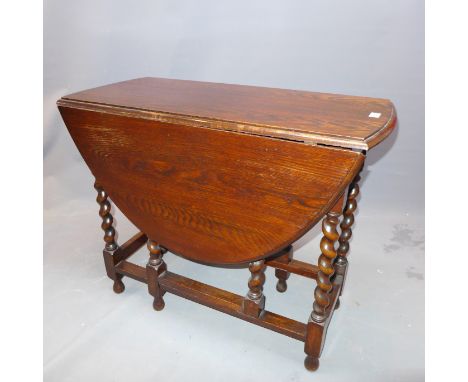 An oak drop leaf gate leg table with burley twist legs, H:52cm W:89cm