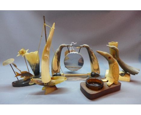 A collection of five 20th Century carved horn desk ornament to include two pew holders, an inkwell, a model of a boat and a g