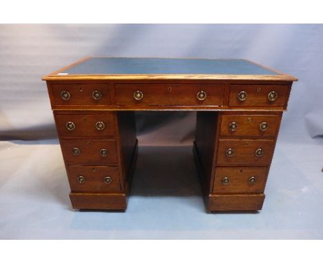 A 19th Century oak painters desk with green inlay top, W;105cm