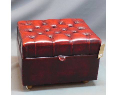 A red leather button down ottoman. 