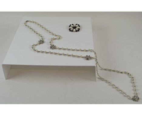 CHANEL ENAMEL BLACK AND WHITE BROOCH, marked Chanel 12A, made in France, together with a Chanel CC faux pearl rope necklace, 