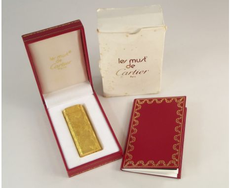 CARTIER LIGHTER. A Les Must de Cartier, Paris, gold plated cigarette lighter. Fully stamped &amp; No.54984. Original case, do