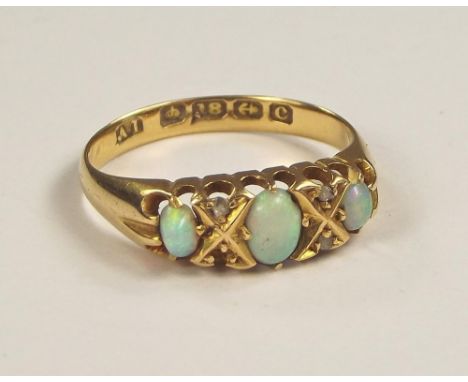 OPAL RING. An Edwardian 18ct. gold opal &amp; diamond ring. Size M.