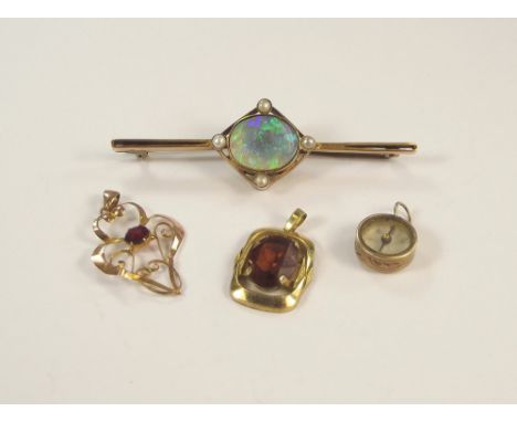 PENDANTS ETC. A 9ct. gold garnet set pendant drop, a synthetic opal bar brooch, a compass fob etc.