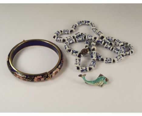 CHINESE BEADS ETC.A string of Chinese ceramic beads, a cloisonne hinged bangle & a silver enamelled fish brooch.