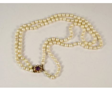 PEARL NECKLACE. A twin strand cultured pearl necklace, with a 9ct. gold amethyst &amp; half pearl clasp.