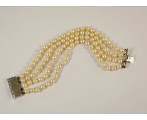 PEARL BRACELET. A cultured pearl bracelet, with 9ct. white gold textured clasp.