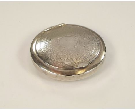 POWDER COMPACT. A 1920's small engine turned, silver coloured metal powder compact.