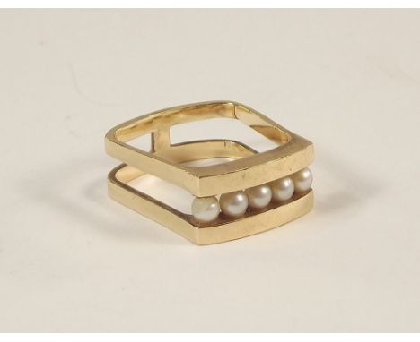 PEARL RING. A modernist 9ct. gold pearl set ring, with split shank. Size J/K. Approx. 5g.