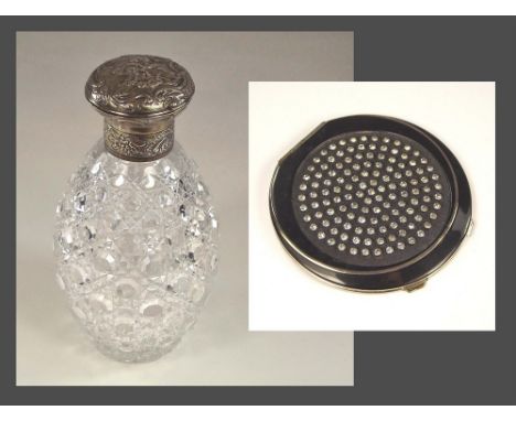 POWDER COMPACT ETC.An Art Deco black enamelled & paste powder compact & a Victorian cut glass scent bottle with hinged lid.