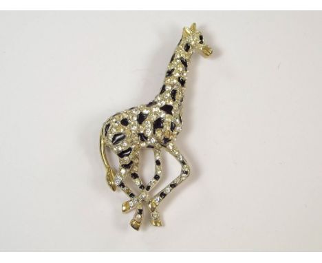 COSTUME JEWELLERY. A silver tone, enamel &amp; paste set giraffe brooch. Height 9.5cm.