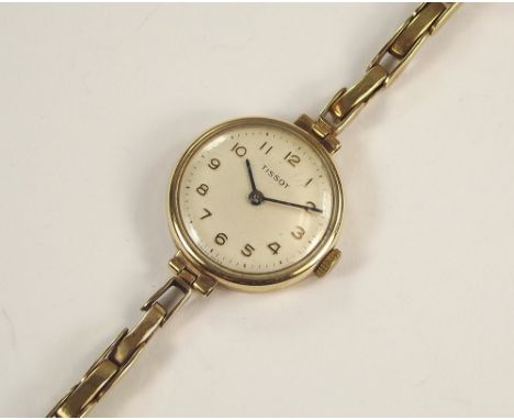 GOLD WATCH. A lady's 9ct. gold cased Tissot wristwatch, with 9ct. gold bracelet strap. Total weight approx. 15g.