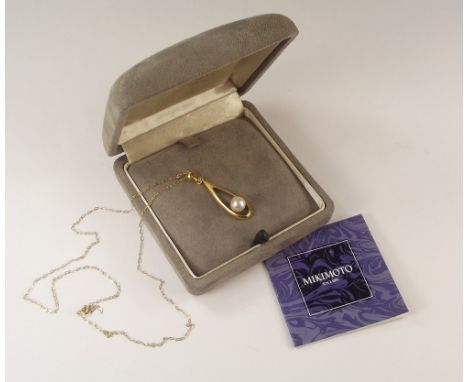 MIKIMOTO. A Mikimoto cultured pearl pendant, set in 18k. gold, with 9k. gold chain. In original Mikimoto box with leaflet.
