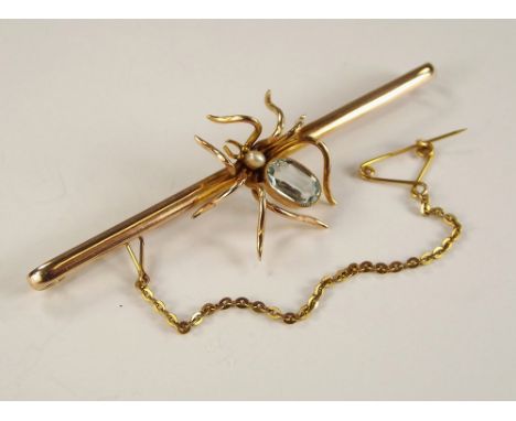 SPIDER PIN. A 9ct. gold bar brooch, mounted a pearl &amp; aquamarine spider. Length 7.5cm.