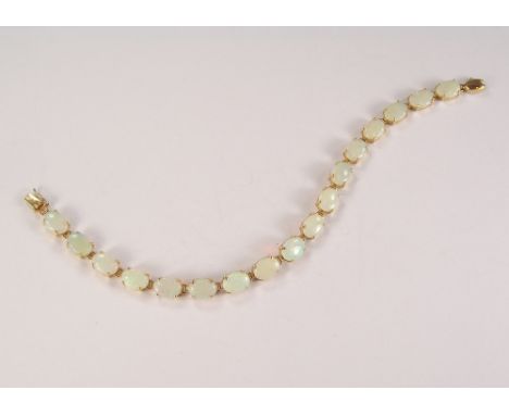 OPAL BRACELET. A 14k. opal set line bracelet.