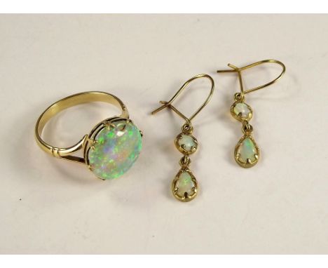 OPAL RINGS ETC. A hand made yellow metal opal ring, unmarked, size of stone 1.3cm. Size N. Also, a pair of opal drop earrings