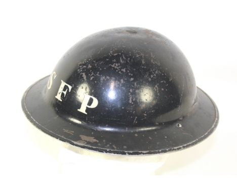 A WWII era Home Front steel helmet marked to front S.F.P.