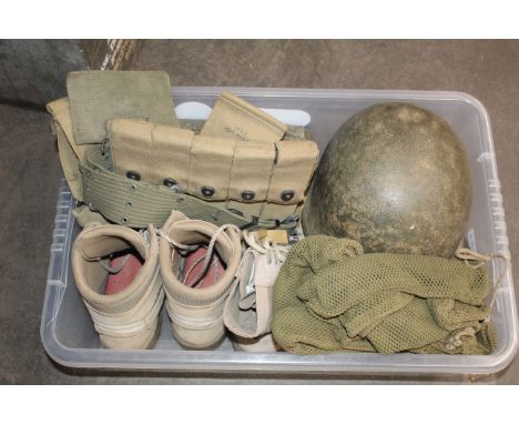 A mixed lot including two pairs of boots (size 9); a U.S. helmet shell, poncho and various webbing items