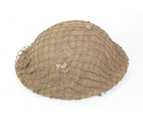 A WWII era Army steel helmet with netting etc.