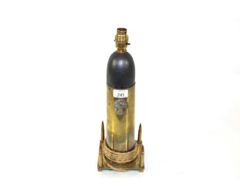 A bespoke table lamp crafted from a brass shell case and four inert rifle rounds 