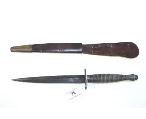 A MkIII F & S fighting knife with sheath, bottom of grip marked with broad arrow and No.2