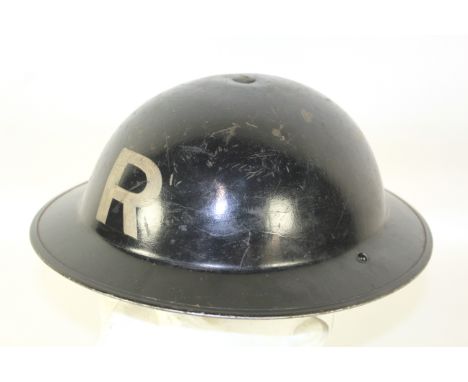A WWII era Home Front steel helmet marked "R" (Rescue)