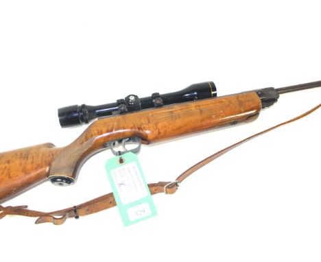 A Weihrauch Model HW35 .22 Cal. air rifle, with a 4 x 10 A.S.I. scope, leather sling and sound moderator (NB slight surface r